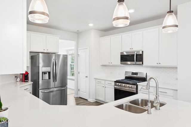 kitchen featuring light countertops, appliances with stainless steel finishes, and a sink