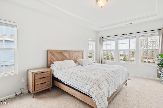 bedroom with light carpet, visible vents, and baseboards