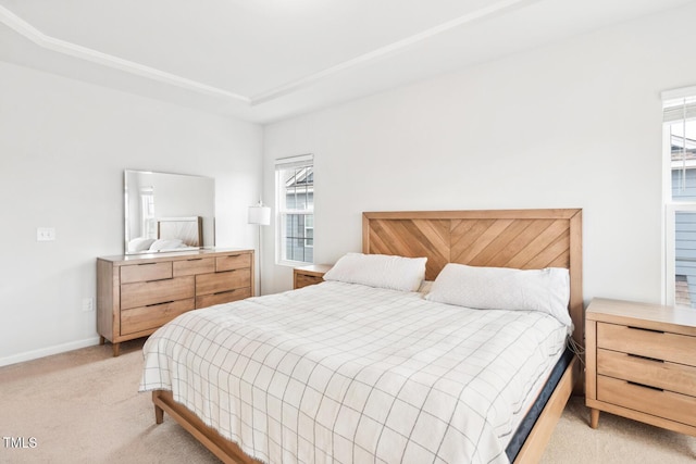 bedroom featuring light colored carpet and baseboards