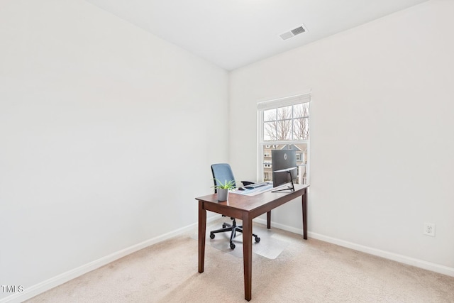 office area featuring visible vents, light carpet, and baseboards