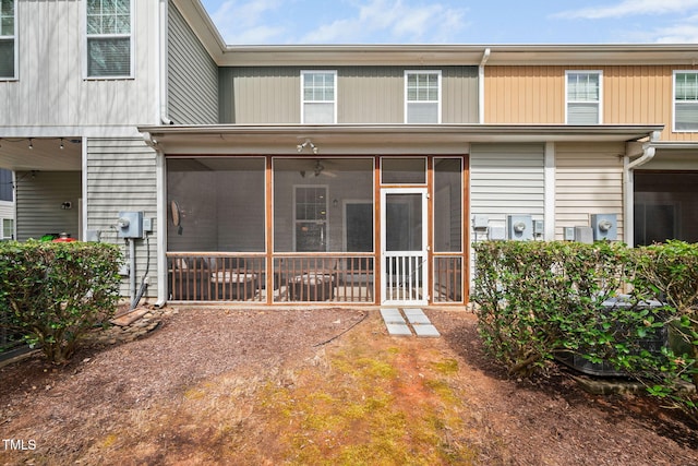 rear view of property with a sunroom