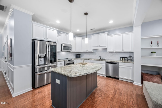 kitchen with white cabinetry, wood finished floors, appliances with stainless steel finishes, and a sink