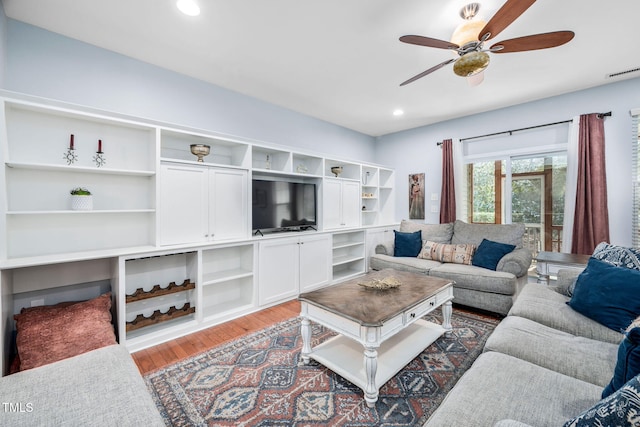 living area with visible vents, recessed lighting, a ceiling fan, and wood finished floors