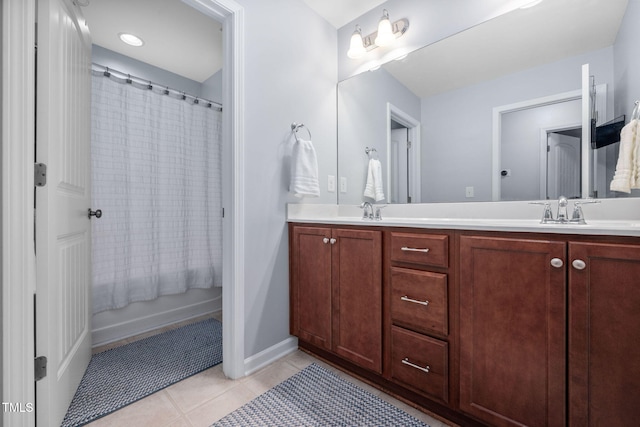 full bathroom with tile patterned flooring, double vanity, and a sink