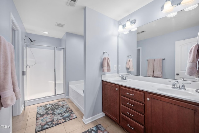 bathroom with visible vents, a shower stall, double vanity, tile patterned floors, and a sink