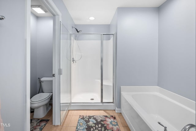 full bath with tile patterned flooring, a garden tub, toilet, and a stall shower