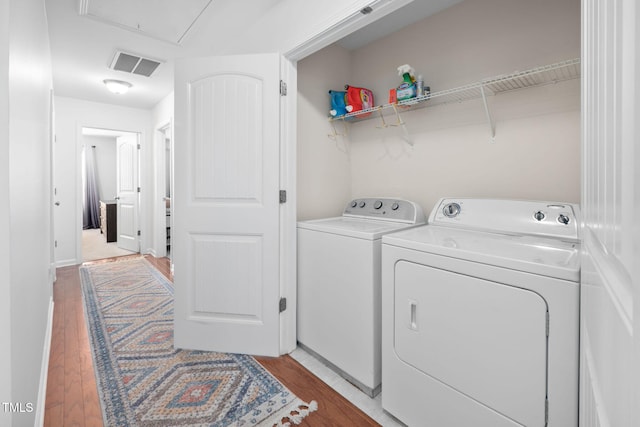 laundry room with visible vents, washer and clothes dryer, light wood-style floors, attic access, and laundry area