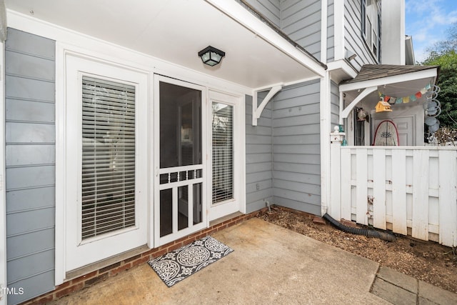 doorway to property with a patio area and fence