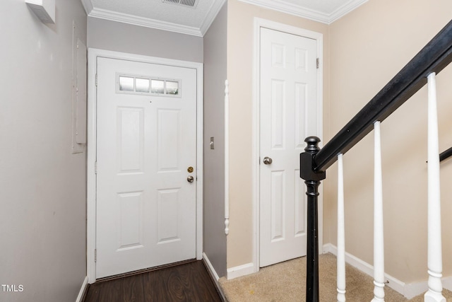 entrance foyer featuring wood finished floors, stairs, baseboards, and ornamental molding