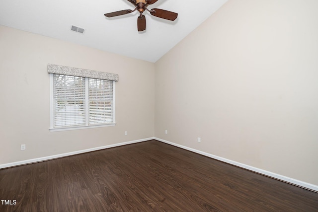 empty room featuring visible vents, dark wood-type flooring, ceiling fan, baseboards, and lofted ceiling