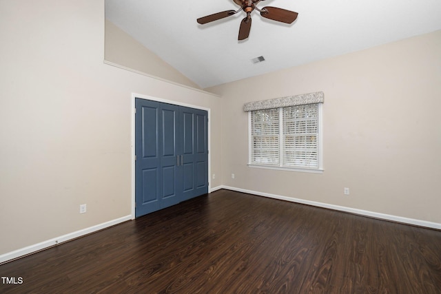 unfurnished room featuring lofted ceiling, wood finished floors, visible vents, and baseboards