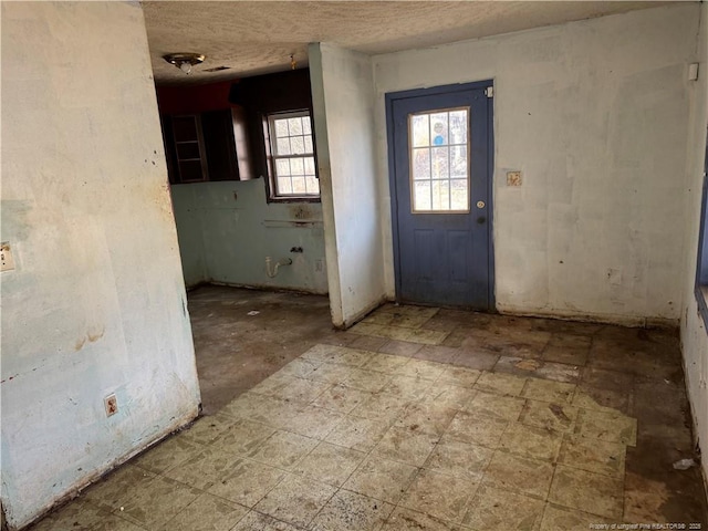 foyer with a textured ceiling