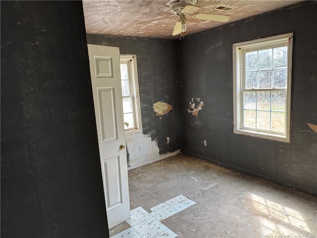 spare room featuring visible vents and ceiling fan