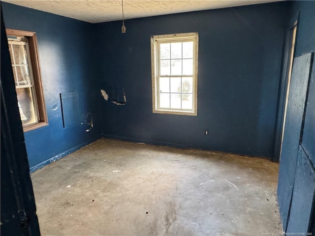 spare room with a textured ceiling