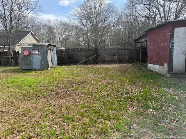 view of yard featuring an outdoor structure, a storage unit, and a fenced backyard