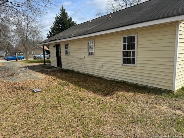 view of home's exterior with a shingled roof