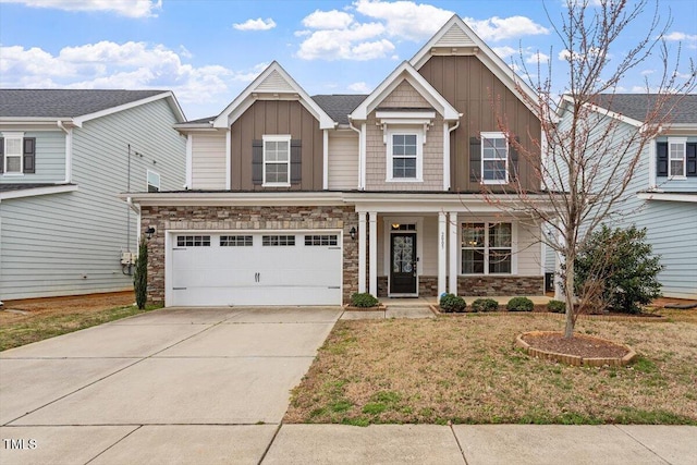 craftsman-style home featuring stone siding, covered porch, board and batten siding, concrete driveway, and an attached garage