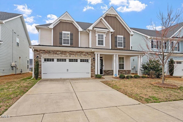 craftsman inspired home with a porch, stone siding, board and batten siding, and driveway