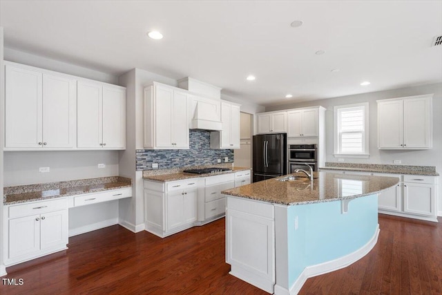 kitchen featuring a sink, appliances with stainless steel finishes, white cabinets, and dark wood-style flooring