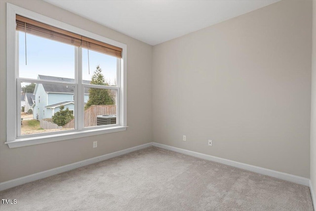 carpeted empty room with baseboards