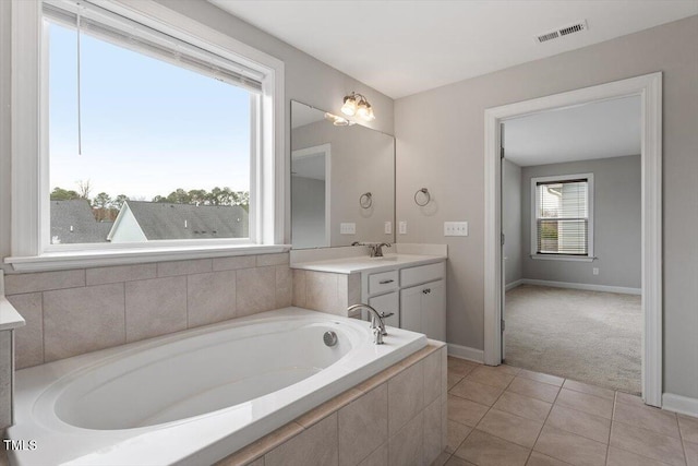 full bath with visible vents, baseboards, a garden tub, tile patterned floors, and vanity