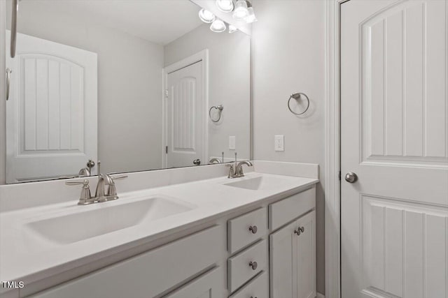 full bath with a sink and double vanity