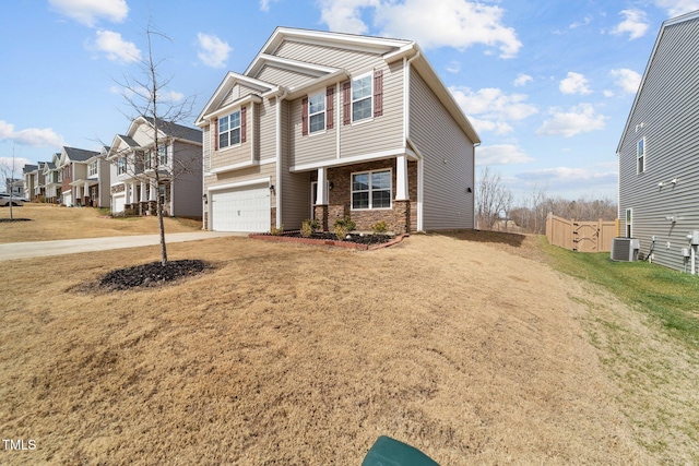 craftsman-style house with concrete driveway, a garage, a residential view, and a front lawn