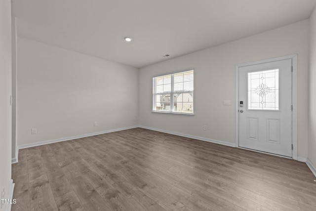 entryway featuring baseboards and wood finished floors