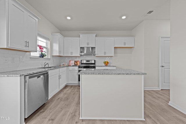 kitchen with white cabinetry, light wood-style flooring, visible vents, and appliances with stainless steel finishes