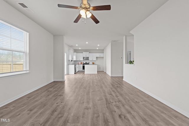 unfurnished living room with visible vents, baseboards, recessed lighting, light wood-style floors, and a ceiling fan