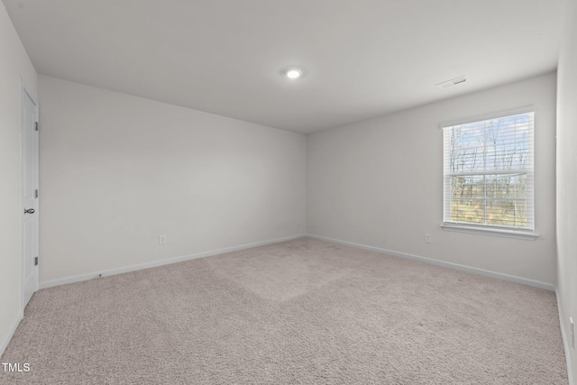 spare room with visible vents, baseboards, and carpet floors