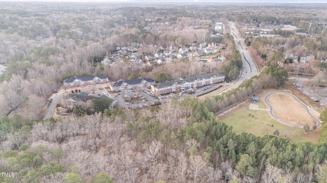 drone / aerial view featuring a wooded view