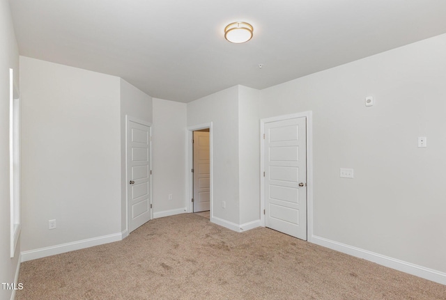 unfurnished bedroom featuring baseboards and carpet