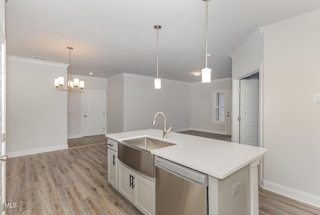 kitchen with a sink, light wood-style floors, dishwasher, and ornamental molding