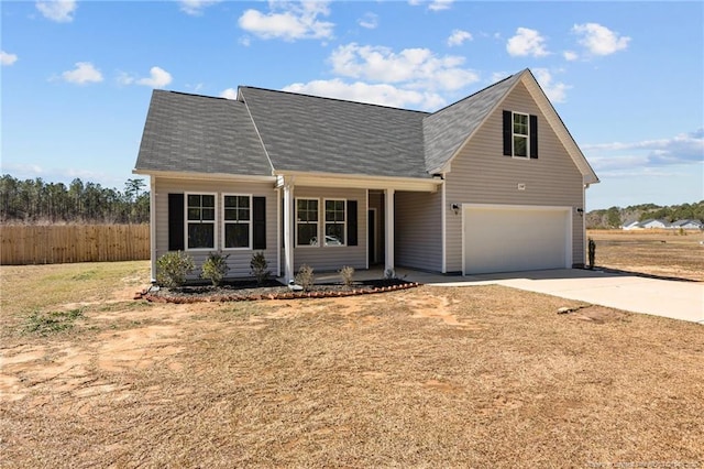 view of front facade featuring concrete driveway, fence, and a garage