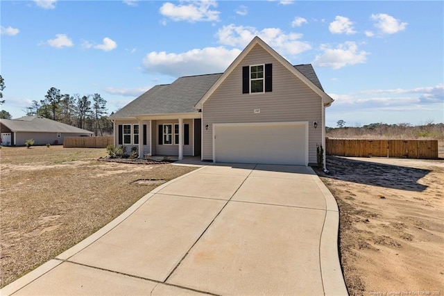 traditional-style home with concrete driveway and fence