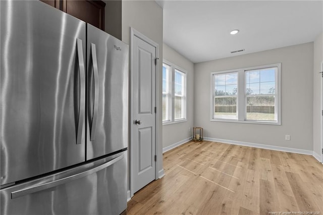 kitchen featuring baseboards, dark brown cabinetry, recessed lighting, freestanding refrigerator, and light wood-style floors