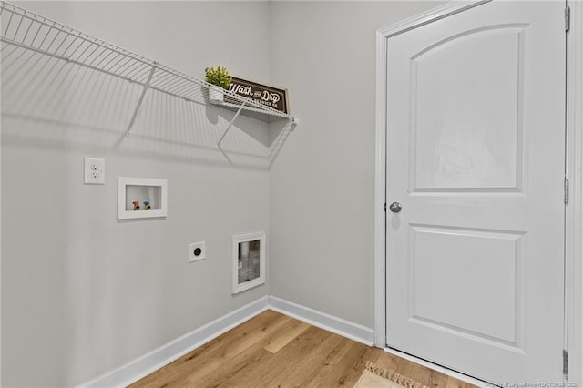 clothes washing area featuring baseboards, hookup for an electric dryer, laundry area, washer hookup, and light wood-type flooring