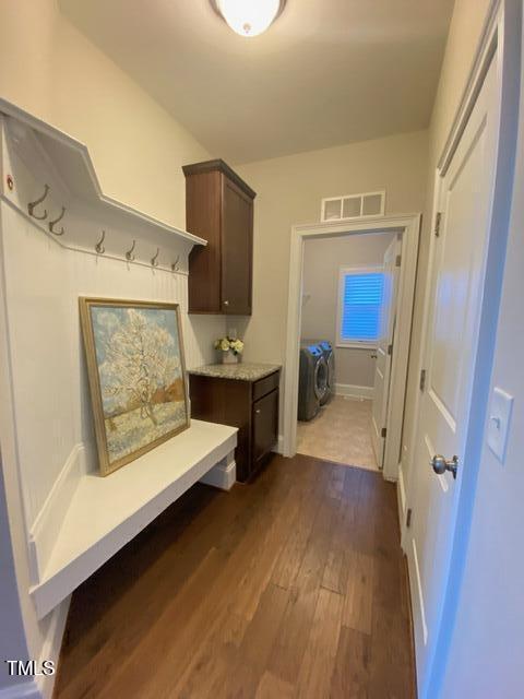 mudroom featuring visible vents and dark wood-style flooring