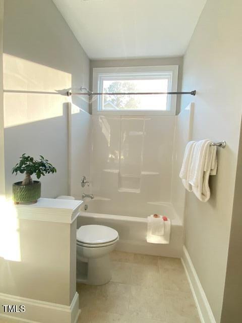 full bath with tile patterned floors, toilet, and bathtub / shower combination