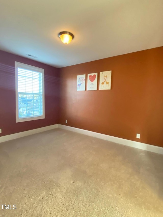 empty room with baseboards and visible vents