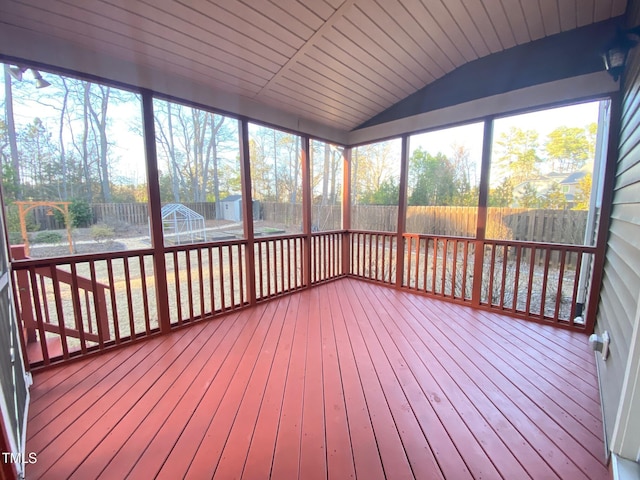 unfurnished sunroom with lofted ceiling and plenty of natural light