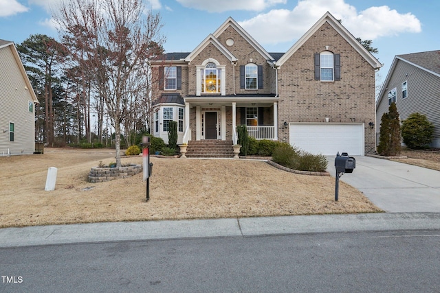 traditional-style home with brick siding, an attached garage, concrete driveway, and a porch