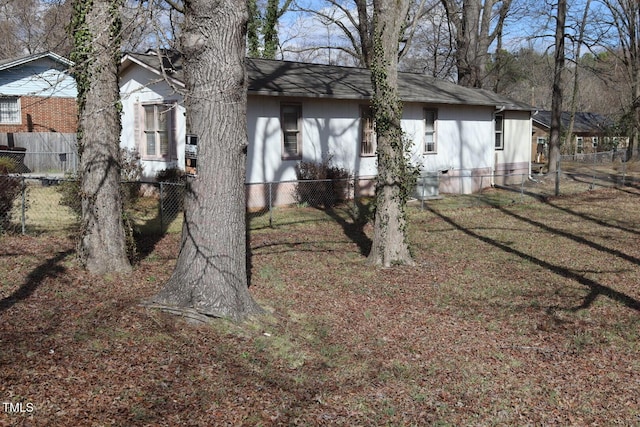 view of home's exterior with a yard, fence, and roof with shingles