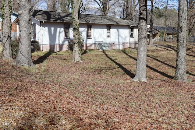 exterior space featuring a front lawn and fence