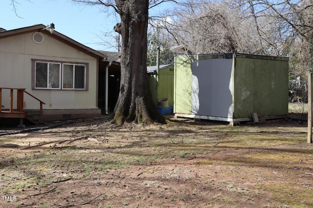 exterior space featuring an outbuilding and a shed