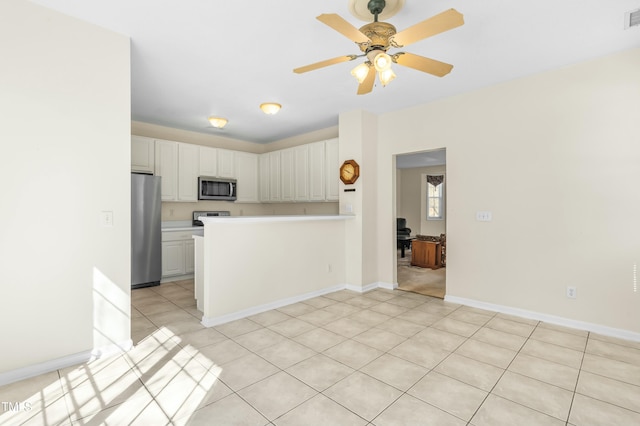 kitchen with visible vents, light countertops, a peninsula, stainless steel appliances, and white cabinetry