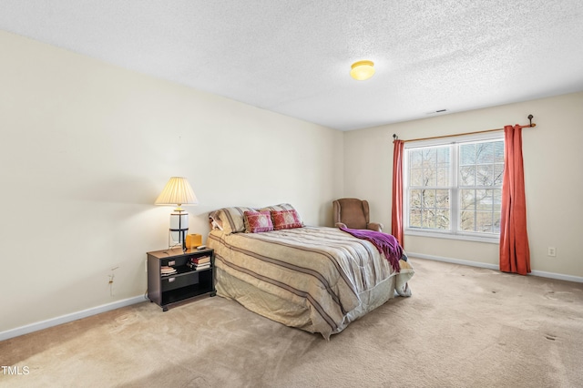 carpeted bedroom with visible vents, baseboards, and a textured ceiling