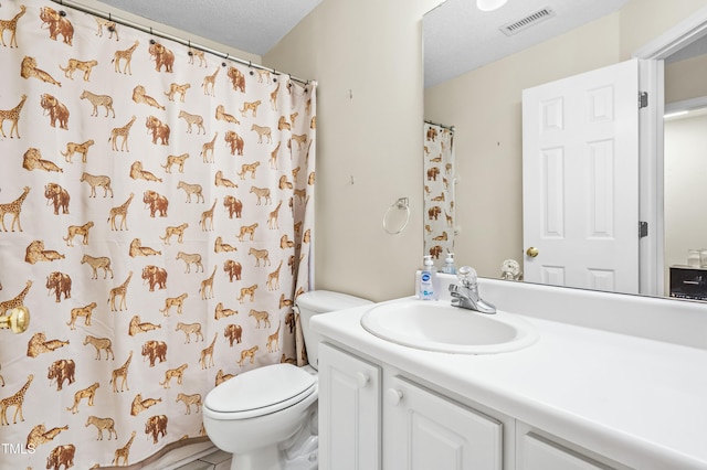 full bathroom with vanity, toilet, visible vents, and a textured ceiling