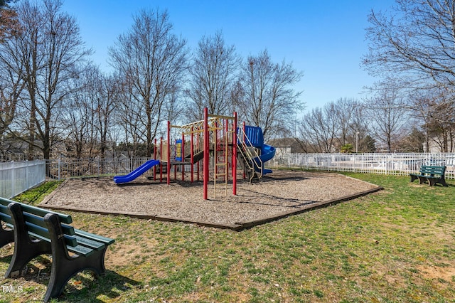 community play area with a yard and fence